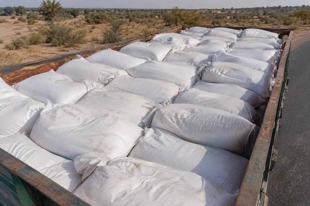 Top-down view of a trailer loaded with white sacks of biomass fuel